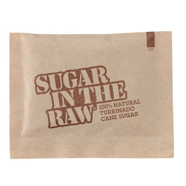 A brown and white Sugar In The Raw packet with text on it.