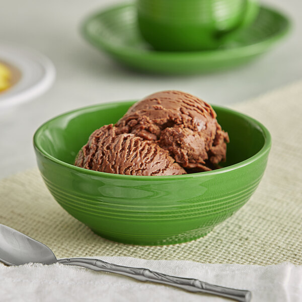 A bowl of chocolate ice cream in a green Acopa Capri stoneware bowl.