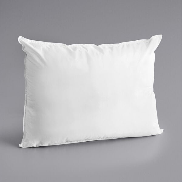 A white Oxford Diamond standard size pillow on a gray surface.