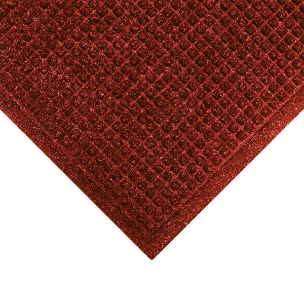 A red WaterHog mat with a square pattern border.