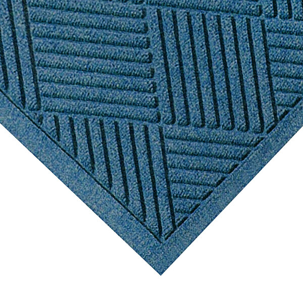 A medium blue WaterHog mat with a square patterned border.