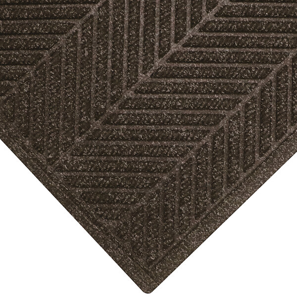 A brown M+A Matting WaterHog Eco Elite mat with a chevron pattern.