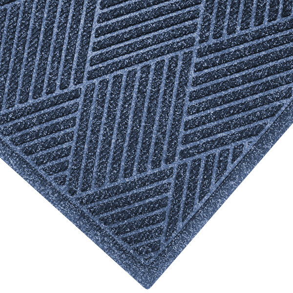 A WaterHog Eco Premier entrance mat with a blue diagonal pattern and a fabric border.