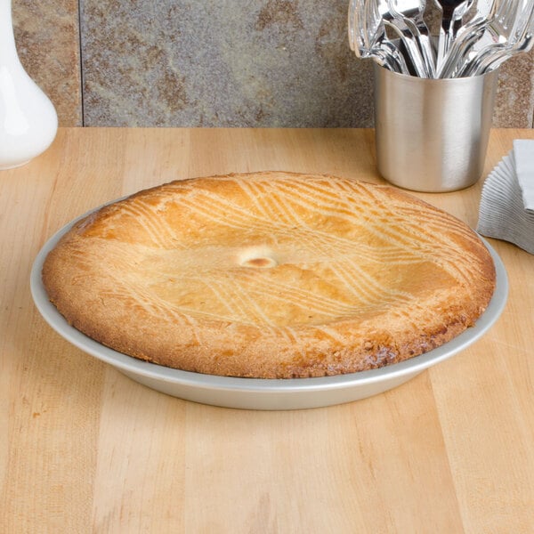 A pie in a Vollrath anodized aluminum pie pan.