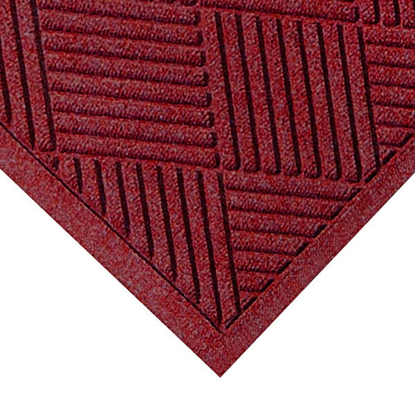 A red WaterHog mat with a square pattern and a black border.