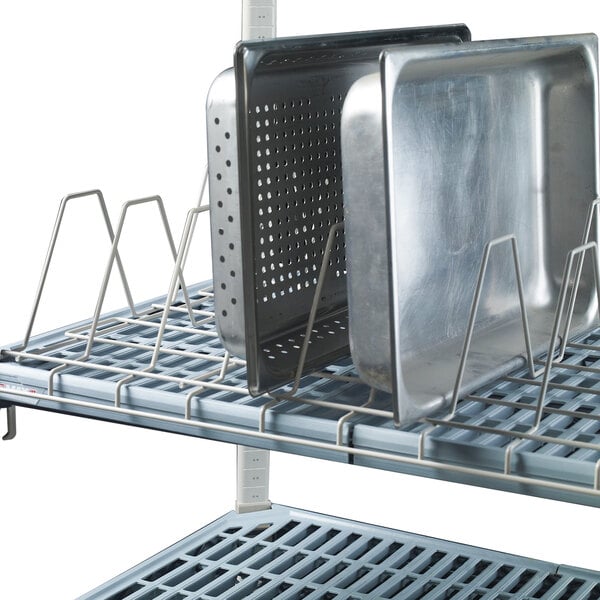 A Metro drying rack with metal trays on it.