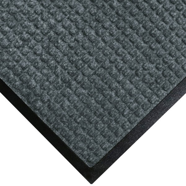 A WaterHog bluestone carpet mat with black rubber border.