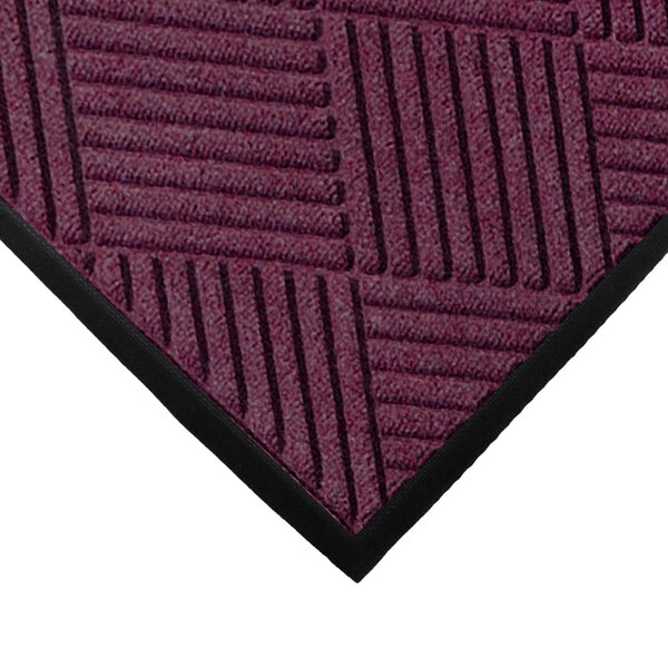 A purple WaterHog mat with black stripes and a rubber border.