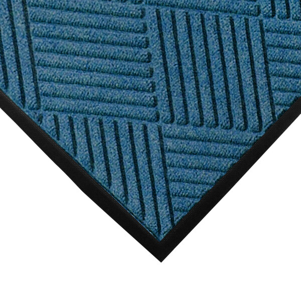 A close-up of a blue WaterHog mat with black diamond lines.