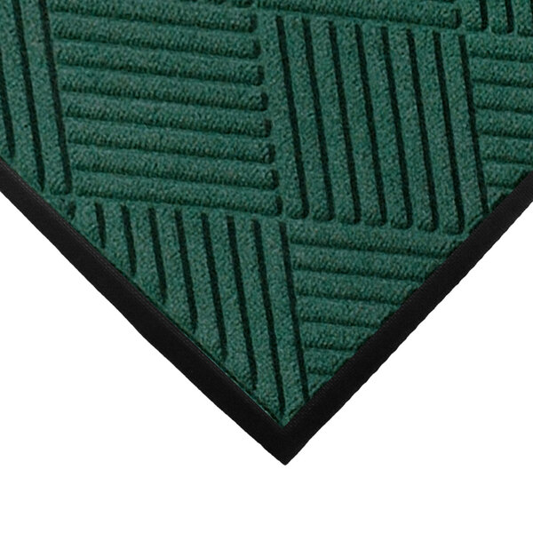 A green WaterHog entrance mat with black stripes.