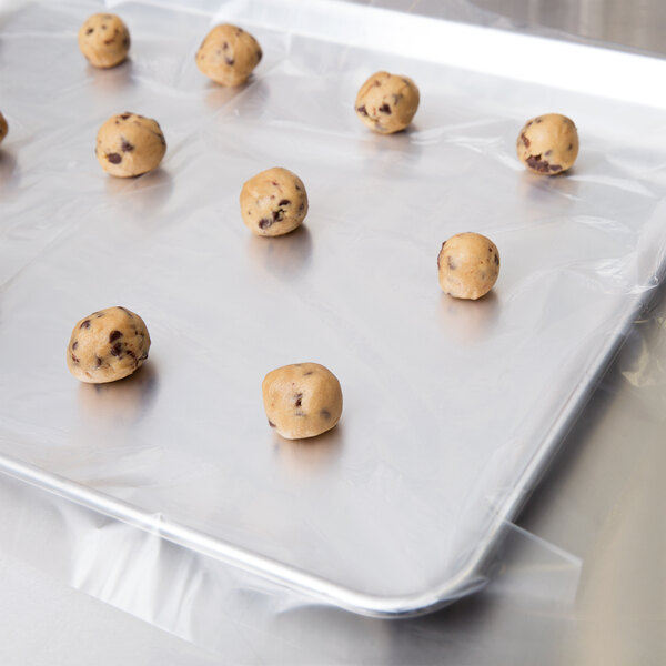 A tray of cookies on a parchment paper lined baking sheet.