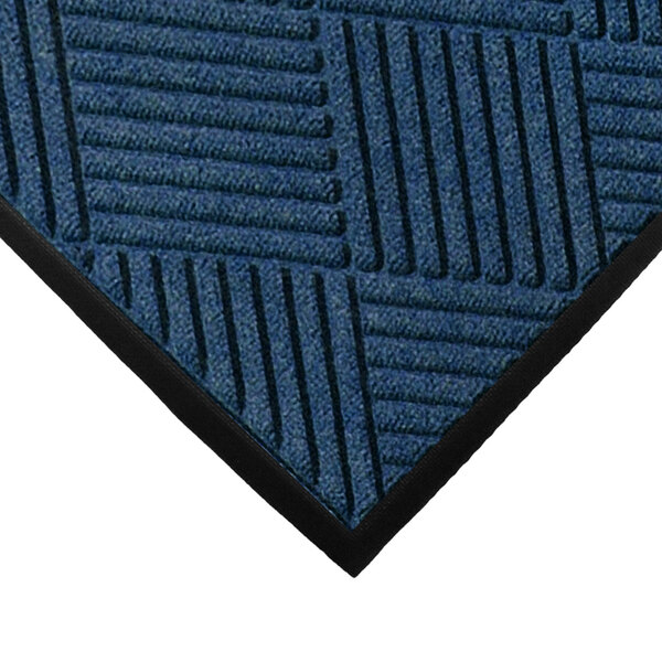 A close-up of a navy blue WaterHog mat with black lines on it.