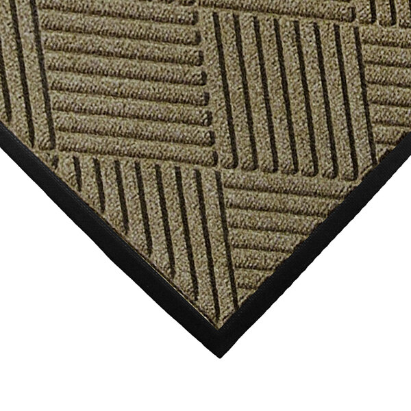 A close-up of a camel WaterHog carpet mat with black lines.