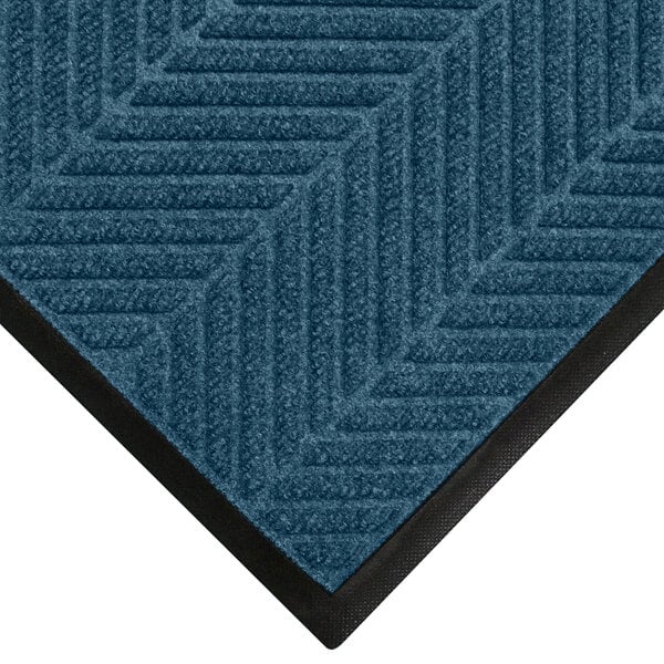 A WaterHog indigo carpet mat with a black border.