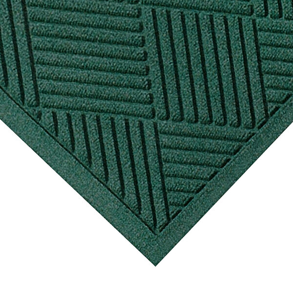 A close-up of a green WaterHog mat with a square pattern.