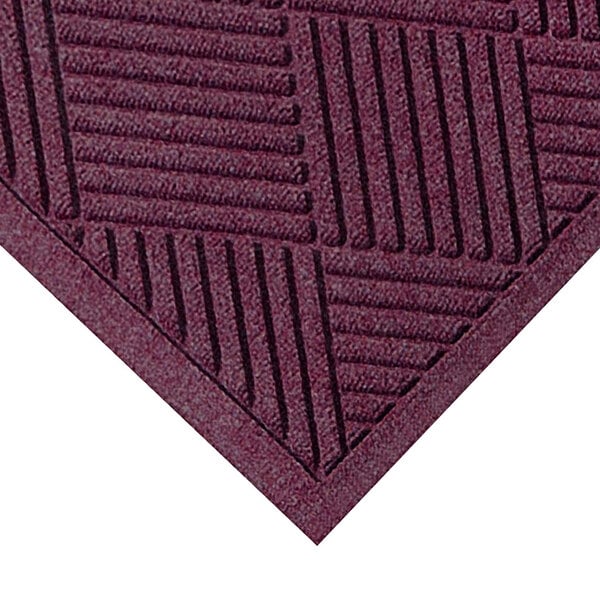 A M+A Matting WaterHog Bordeaux mat with a square patterned border.