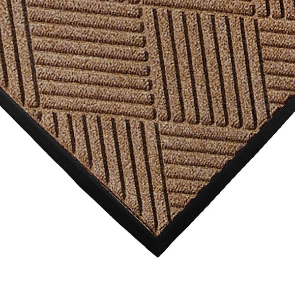 A close up of a brown M+A Matting WaterHog mat with black stripes.