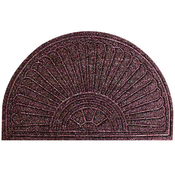 A maroon WaterHog doormat with a circular design.