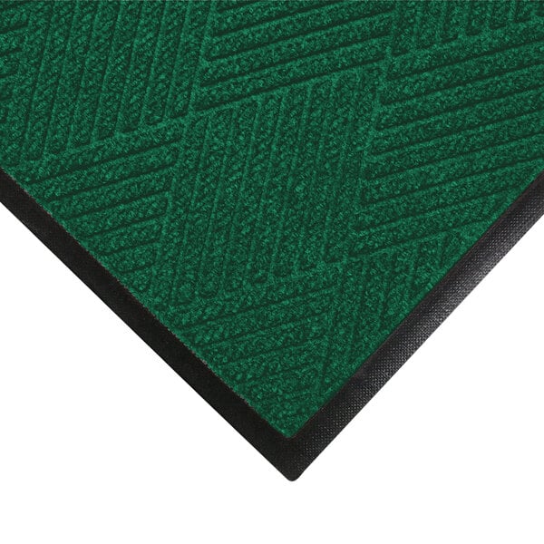 A green WaterHog doormat with black rubber border.