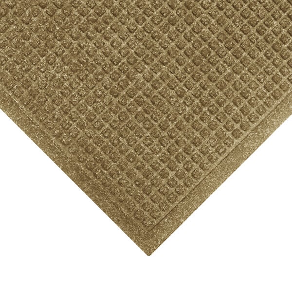 A brown M+A Matting WaterHog mat with a diamond patterned border.
