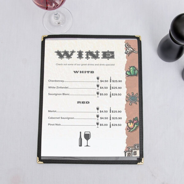 A menu with a Southwest themed desert design on a table with a glass of wine.