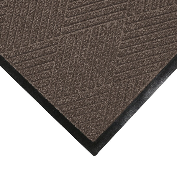 A close-up of a brown WaterHog mat with a black rubber border.