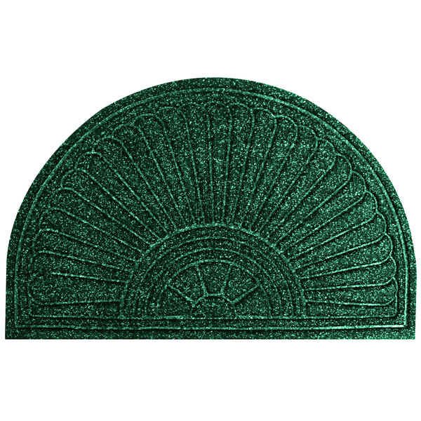 A green doormat with a fan-shaped design.