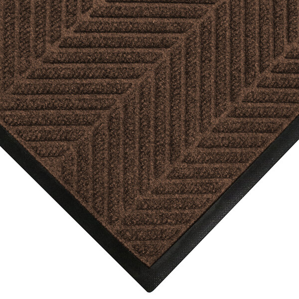 A brown WaterHog entrance mat with black border.
