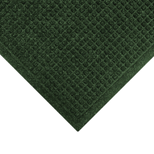 A green WaterHog mat with a square pattern border.