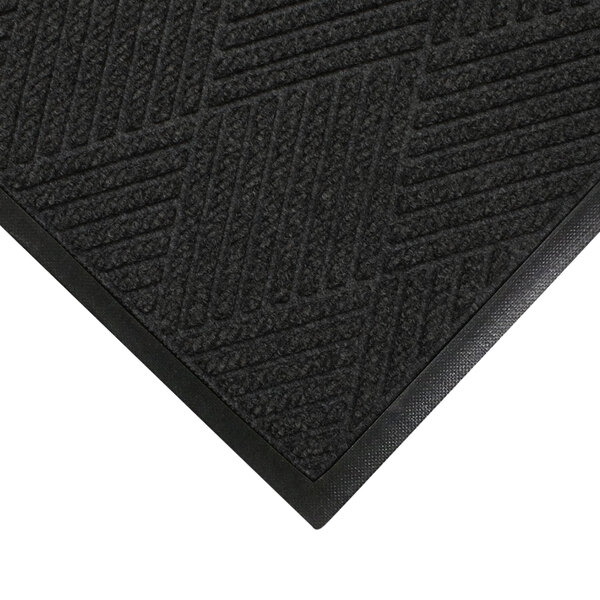A close up of a black WaterHog mat with a rubber border and a patterned surface.