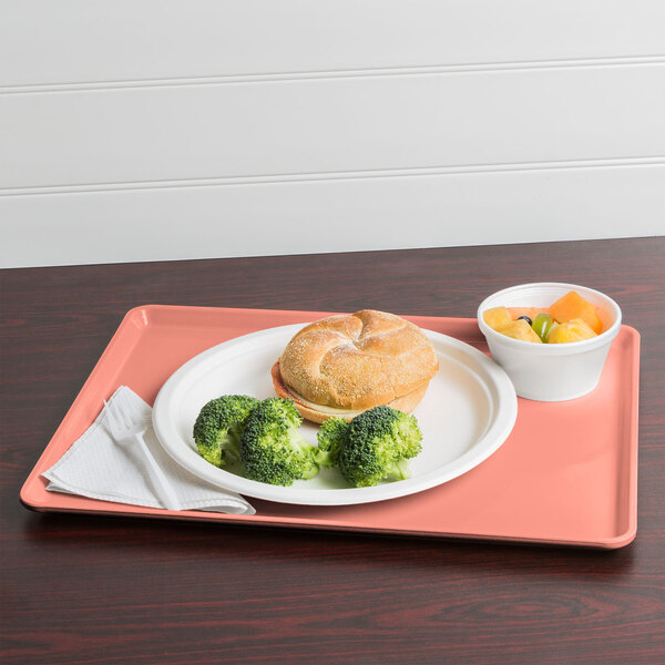A Cambro blush dietary tray with a plate of food including broccoli and a fork.