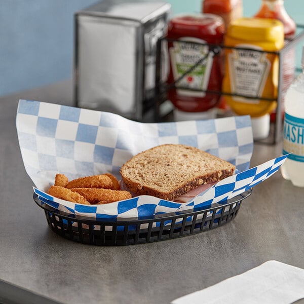 Choice blue check deli wrap paper lining a basket of food on a table.