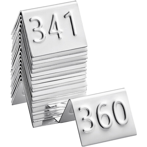 A stack of American Metalcraft stainless steel number table tents with the number 34.