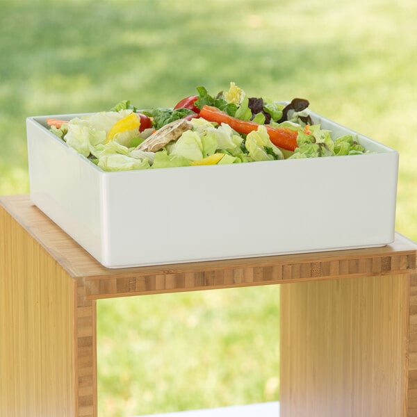 A white Cal-Mil melamine box on a wooden surface.