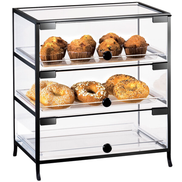 A Cal-Mil Iron three tier display case with bagels, muffins, and doughnuts.