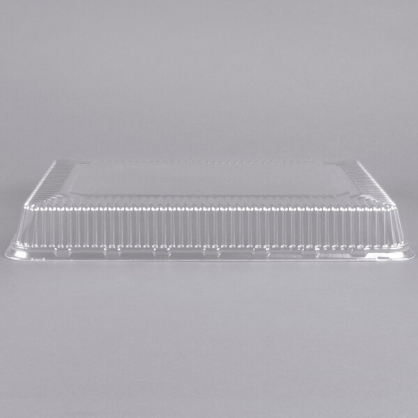 A clear plastic dome cover for a 1/2 sheet cake.