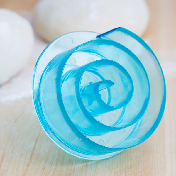 A blue plastic spiral cutter with black lines.