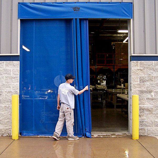 A man in a grey shirt and khaki pants opening a Goff's blue mesh bug door.