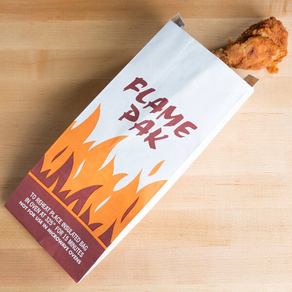 A Bagcraft Packaging foil bag with a "Flame Pak" design holding a chicken leg.