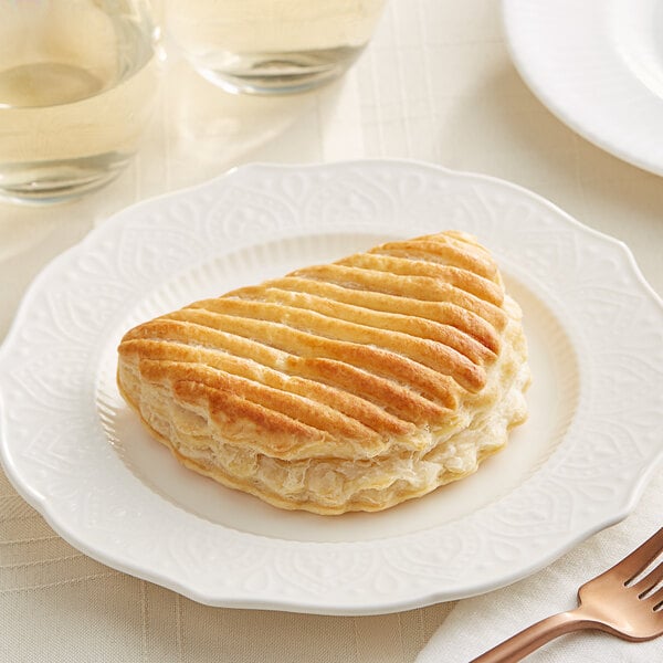 A Bridor apple turnover on a white plate.