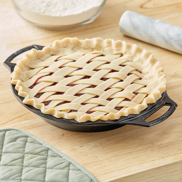 A pie with a lattice crust in a Lodge cast iron pie pan.