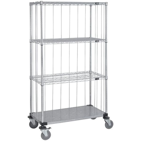 A Quantum metal mobile enclosure cart with 3 wire shelves and 1 steel shelf on wheels.