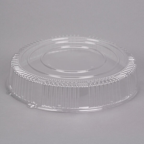 A WNA Comet clear plastic round high dome lid on a clear plastic container.