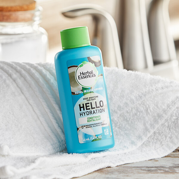 A blue bottle of Herbal Essences Hello Hydration conditioner on a white towel.