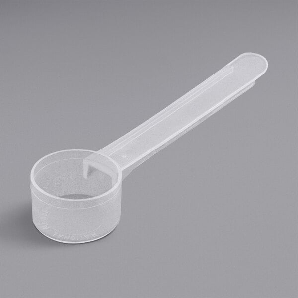 A close-up of an 11 cc polypropylene measuring scoop with a long handle.