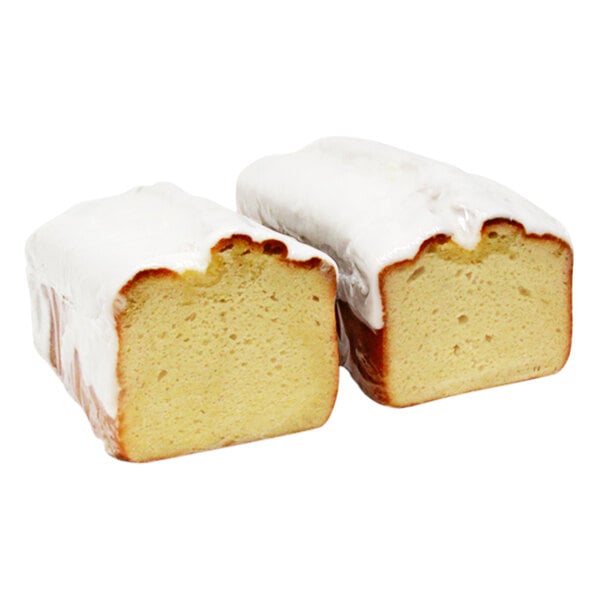 Two slices of Sweet Sam's lemon pound cake with white icing.
