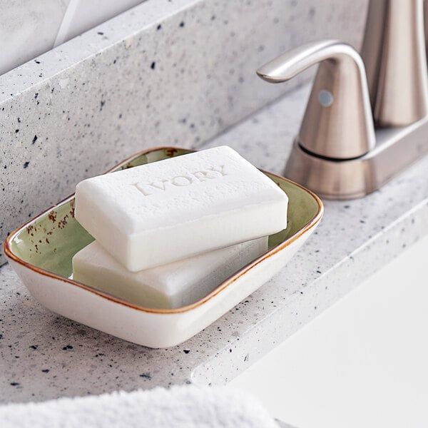A white rectangular Ivory bar soap with text engraved on it.