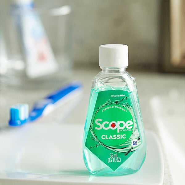 A bottle of Crest Scope Classic Mint mouthwash on a white plate.