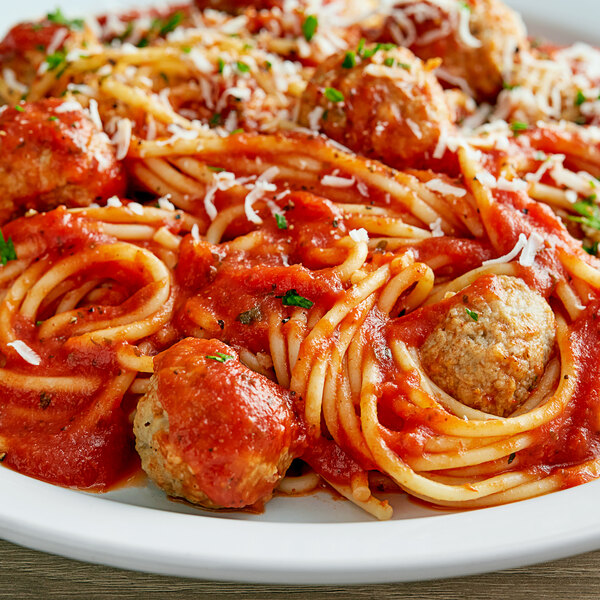 A plate of spaghetti with meatballs and Prego traditional Italian sauce.