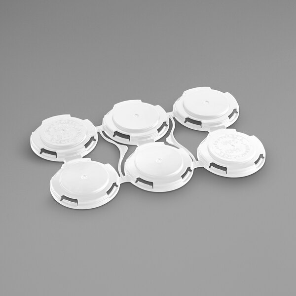 A white plastic PakTech can carrier with six circles.